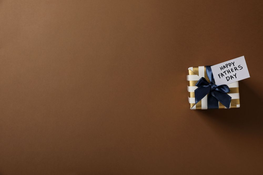 Father's day concept, gifts and greetings, on a brown background.