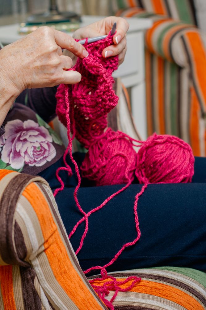 Hands of woman knitting a wool sweater