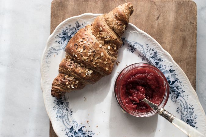 Served breakfast meal with croissant and jam