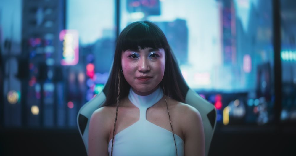Portrait of a Japanese Woman Looking at the Camera and Smiling in a Technologically Advanced Room with Futuristic Cyberpunk City