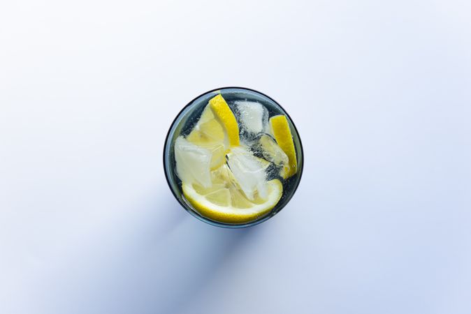 Water with lemon in tall glass top view