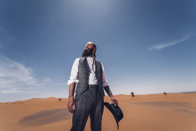 Bearded cowboy in desert
