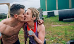 Athletes kissing and showing medals
