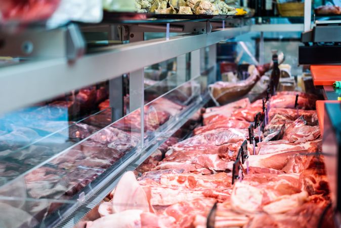 Meat on display behind counter at butchers