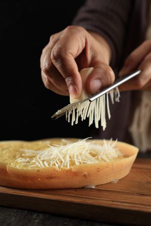 Woman Hand Grating Cheese