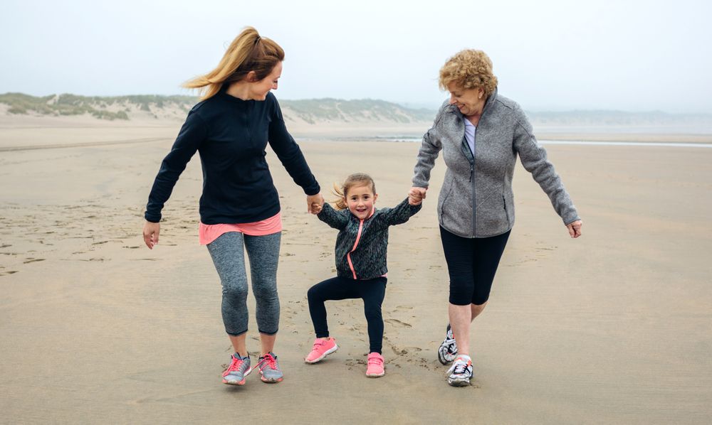 Three generations running on the beach