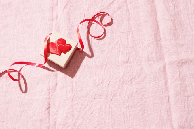 Small gift box with red heart and ribbon, with copy space