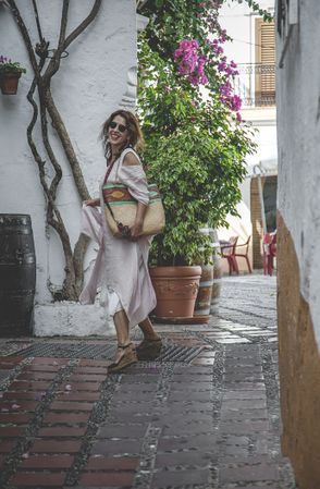 Happy female walking on side street in town