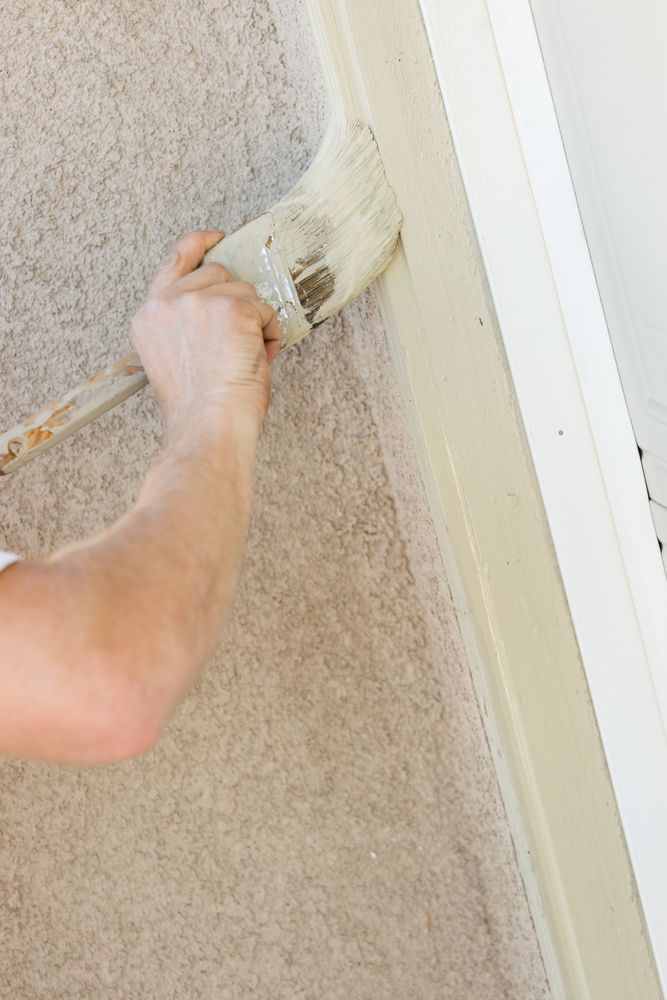 Professional Painter Cutting In With Brush to Paint Garage Door Frame
