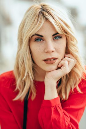 Serious blonde woman with head resting on her hand