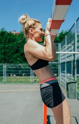 Female athlete doing pull-ups in a goal