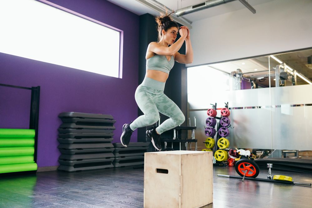 Woman jumping on a box exercising legs