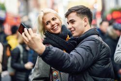 Man and woman taking selfie in UK street