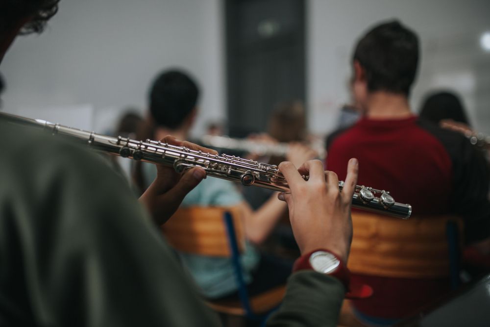 Young student playing with other classmates in band practice
