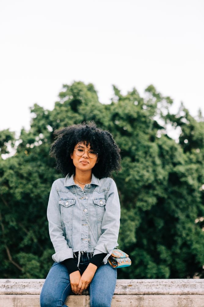Fashionable Black female relaxing in city