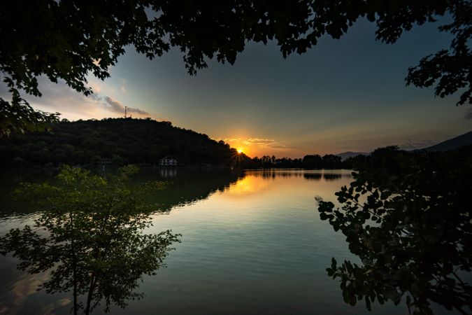 Lopota lake with reflection of mountains at dusk