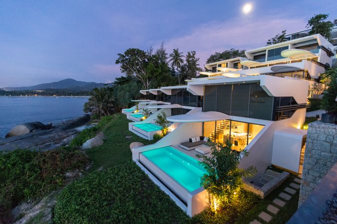 A modern home with pool beside seashore