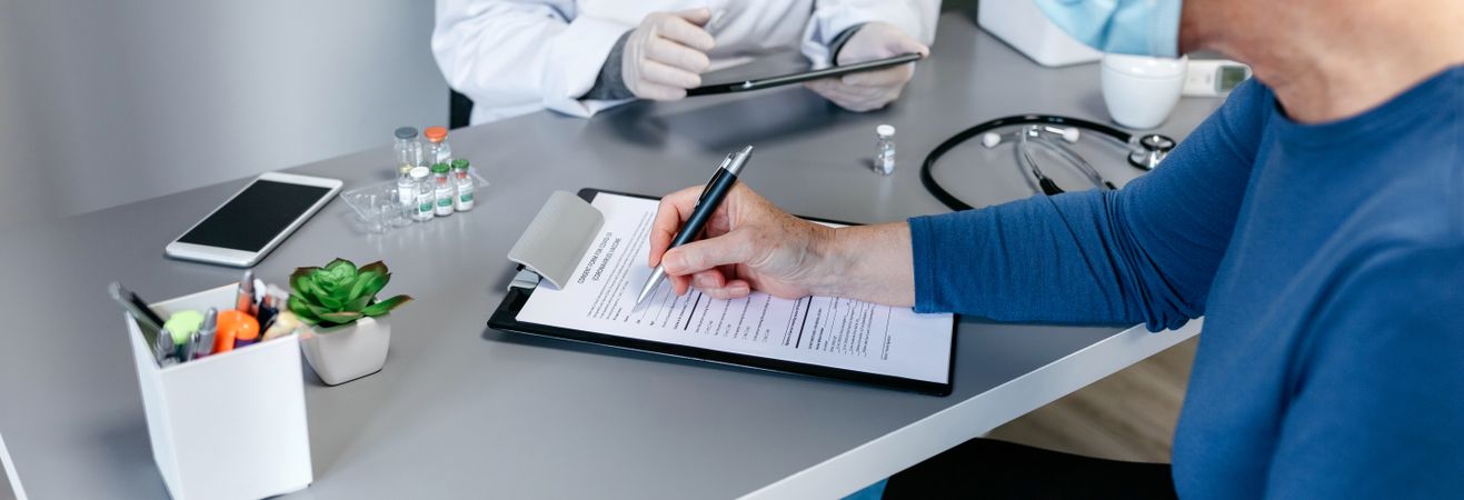 Woman filling in consent form for coronavirus vaccine