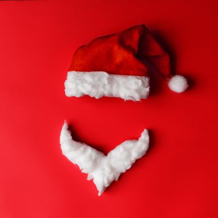 Santa hat and beard on red background