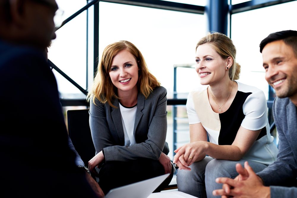 Male and female business associates having an informal meeting in an office
