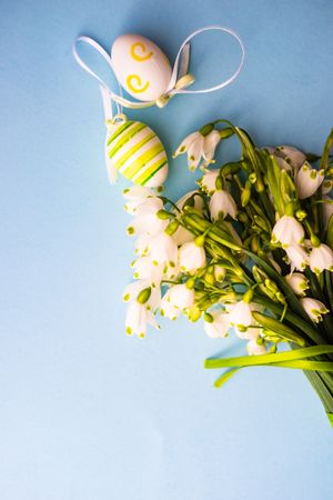 Easter holiday card concept with snowdrops bouquet and decorative eggs