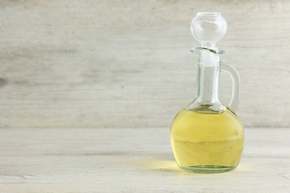 A Bottle of Olive Oil in Light Wooden Table