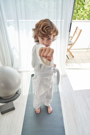 Boy practicing punches at home