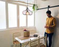 Man drinking hot tea during knitting