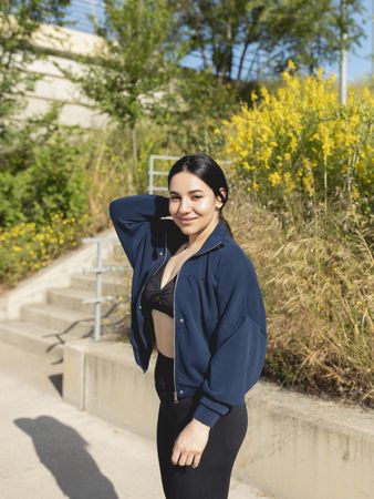 A young woman poses during a walk in the park, in a sunny morning, in Zaragoza, Spain