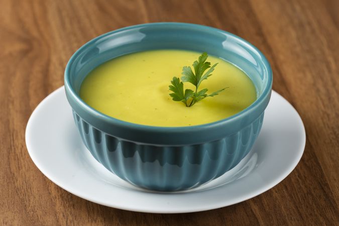 Bowl with onion soup and croutons on the table.
