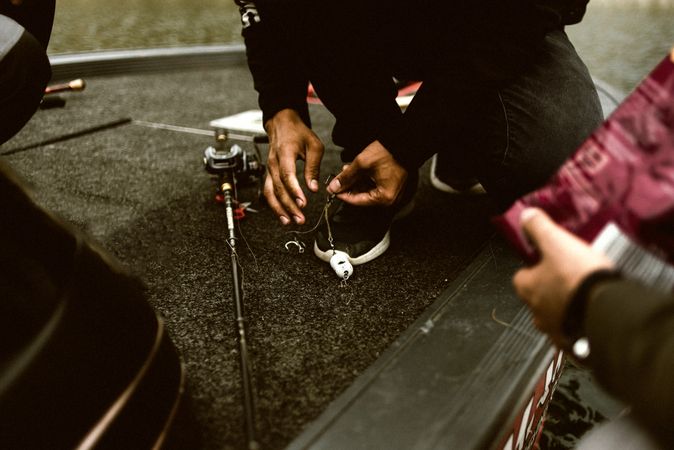 People preparing fishing gear for fishing on ground