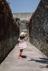 Girl in narrow stone walkway