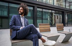 Glad entrepreneur smiling while sitting outside