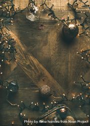 Christmas tree decorations, arranged on wooden counter, with copy space in center 49NVBb