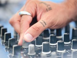 Crop DJ adjusting sound of music