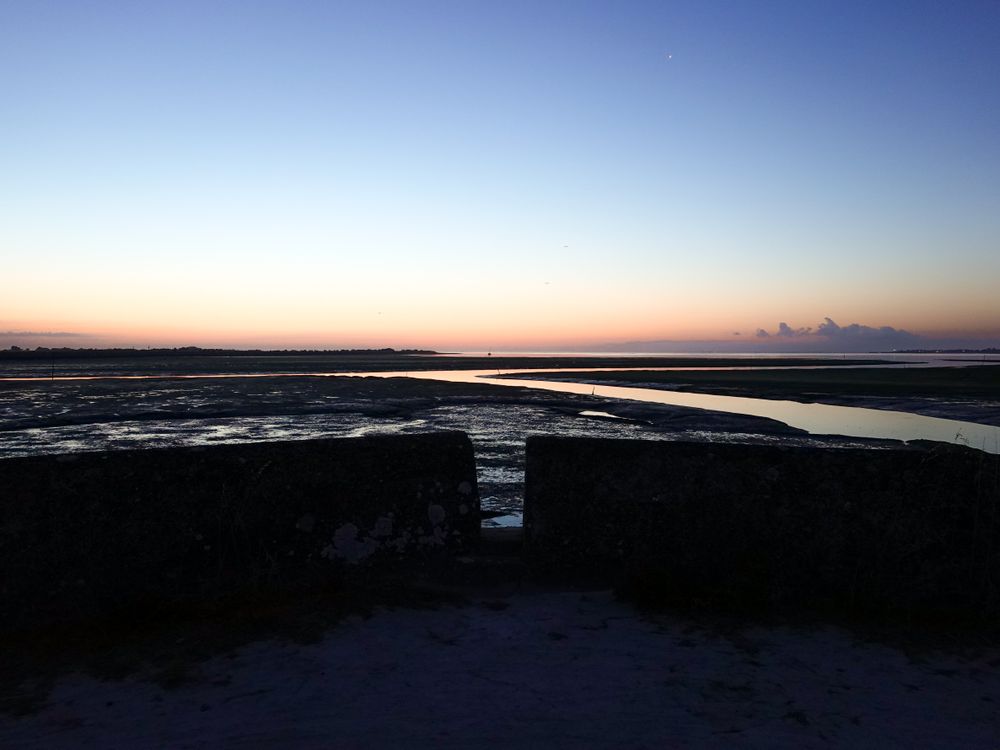 A view of the Fossé de Loix at low tide from the dike to the Port of Loix, France.