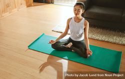 Healthy young woman exercising yoga in living room 5a7LGb