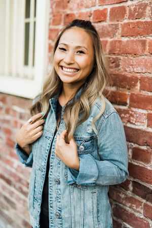 Smiling woman in blue denim jacket