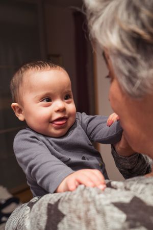 Portrait of cute baby boy with Down syndrome