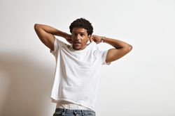 Man making funny face as he begins to take off his t-shirt