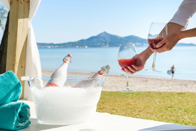 Person serving champagne on beach