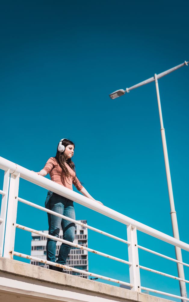 Teen girl watching the street while listening to music.