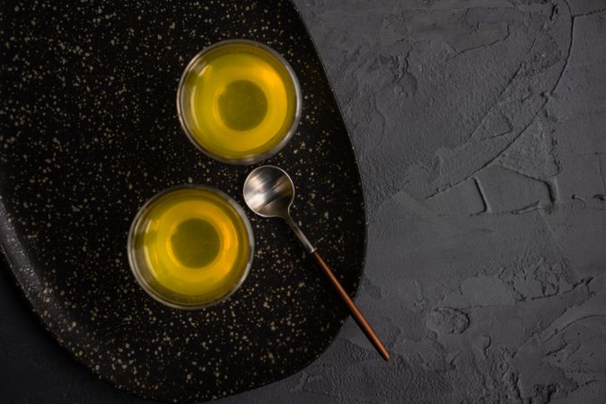 Top view of two glasses of Italian digestif limoncello with spoon