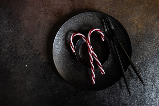 Festive table setting for Christmas dinner with candy cane decor