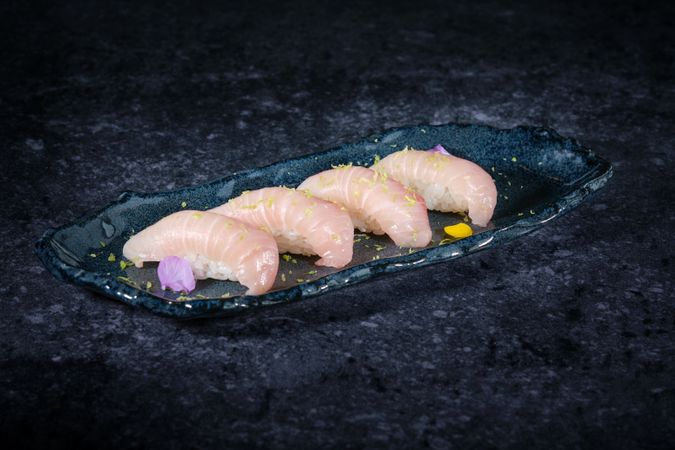 Sushi on fish and rice on ceramic plate