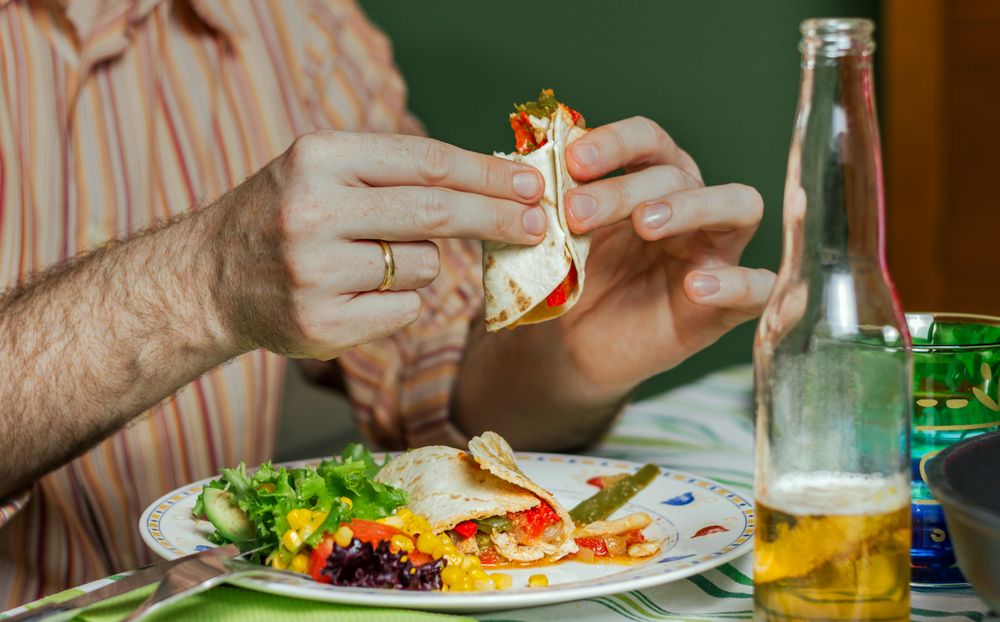 Man hands eating mexican food