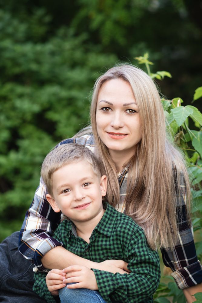Portrait of mother spending time with son in backyard