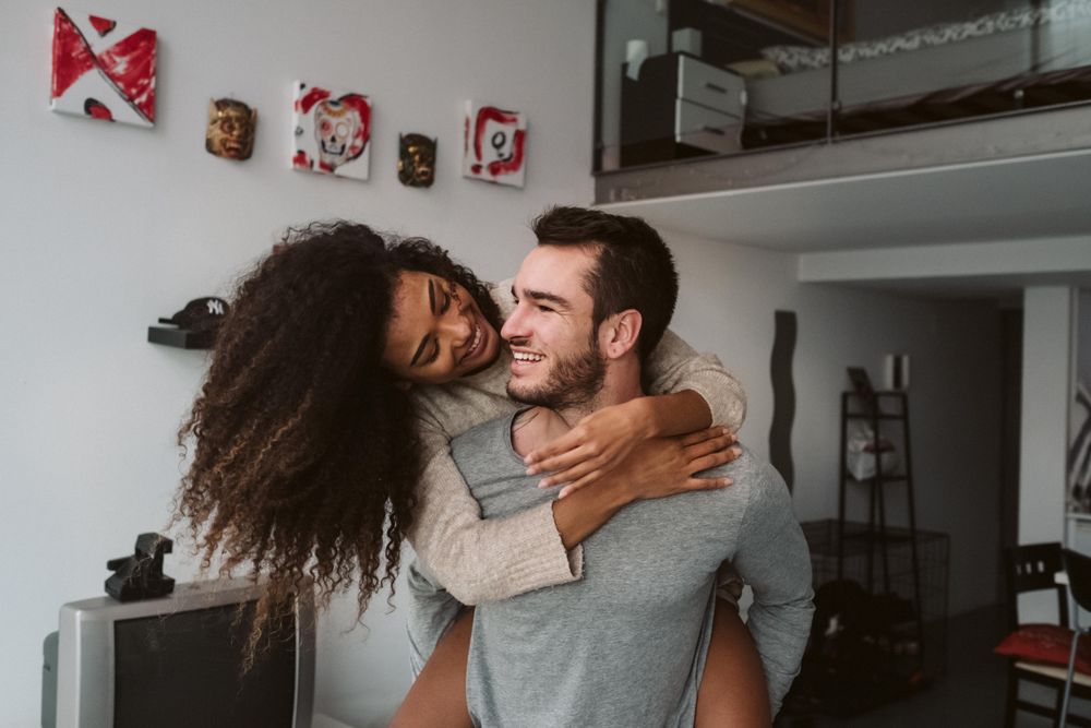 Multiracial couple having fun at home