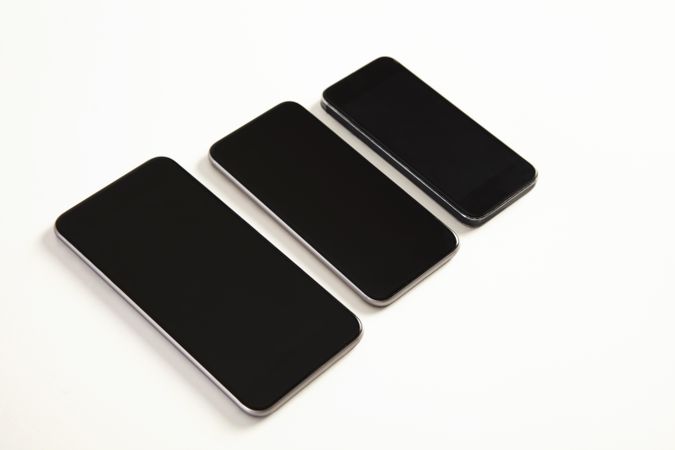 Three phones on blank background