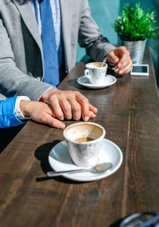 Couple of coworkers holding hands
